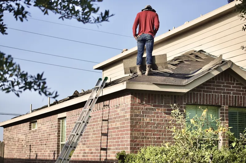 Professional roofer working on a residential roof in Tibbetts Corners